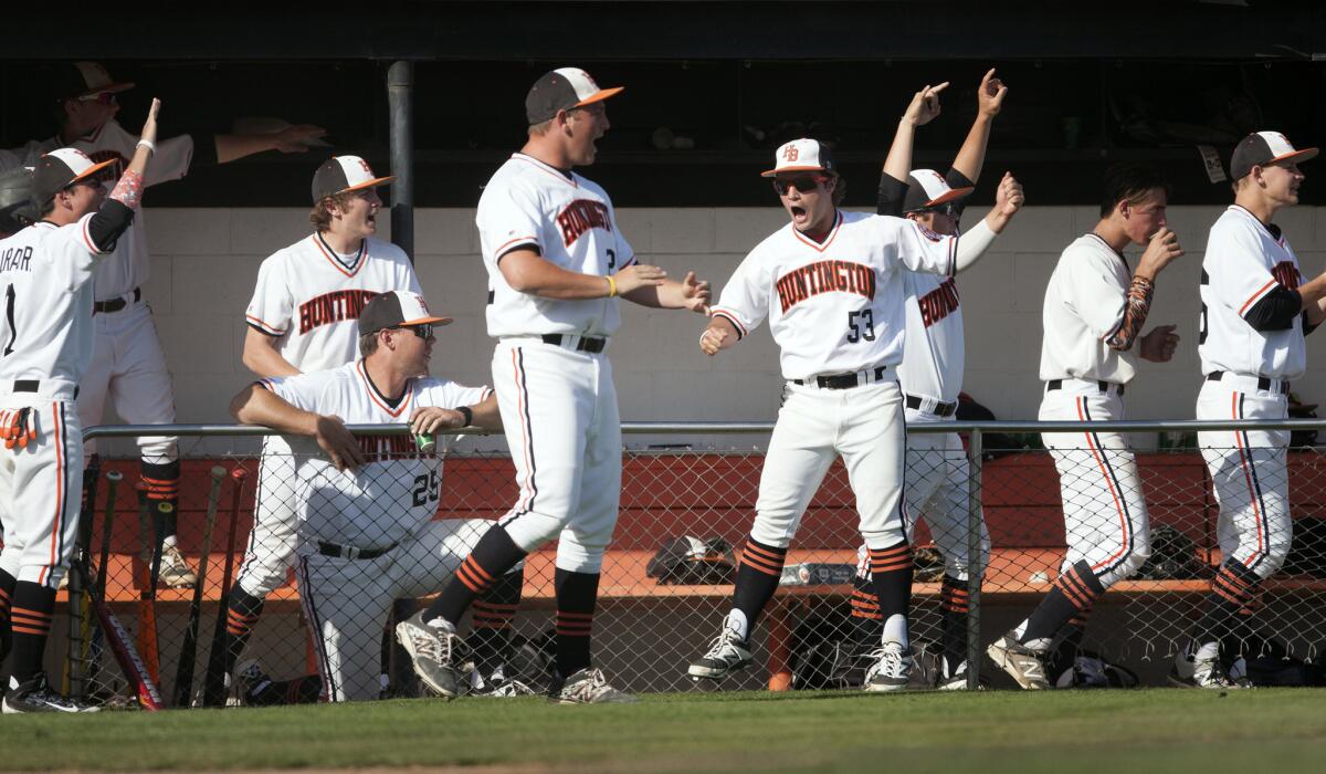 Huntington Beach players celebrate during their 9-5 victory over Sunset League rival Edison on Friday.
