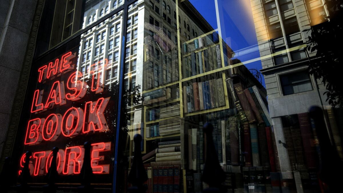 The neon sign in the window of the Last Bookstore reflects the past and present on the corner of Spring and 5th streets in downtown.