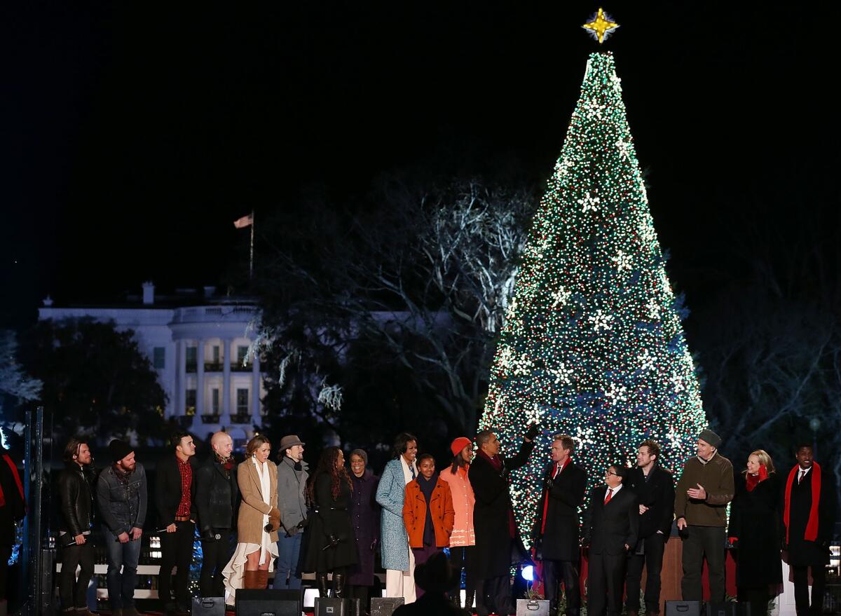 WASHINGTON, DC - DECEMBER 06: U.S. President Barack Obama and his family are joined by entertainers onstage while singing Christmas songs during the annual lighting of the National Christmas tree on December 6, 2012 in Washington, DC. This year is the 90th annual National Christmas Tree Lighting Ceremony. (Photo by Mark Wilson/Getty Images) ** TCN OUT **