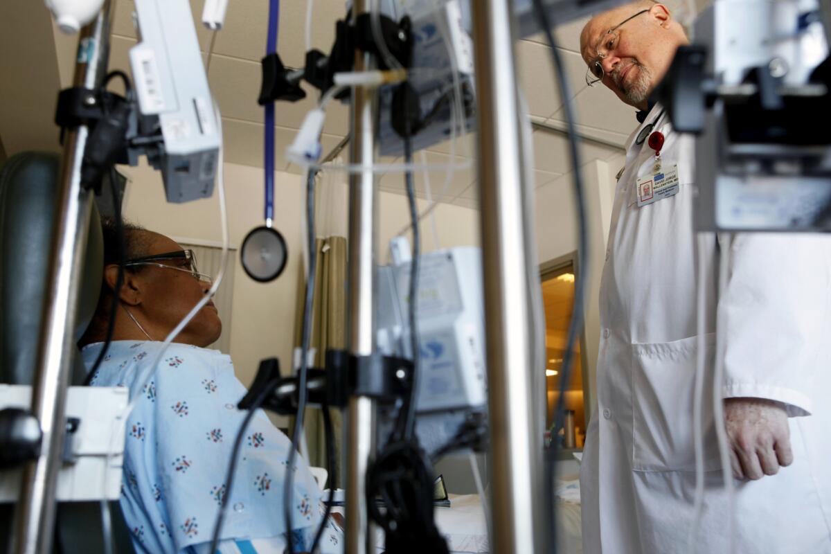 Dr. David Wallenstein, a clinical assistant professor of family medicine who works with UCLA's Palliative Care Service, visits Harriet Fields, 61.