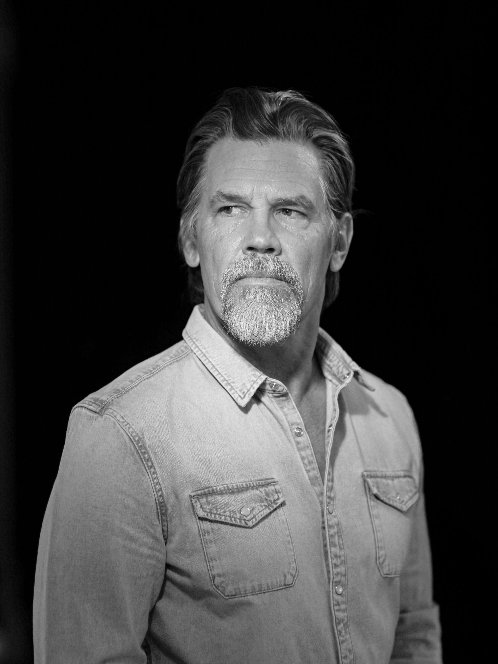 A man against a black background.