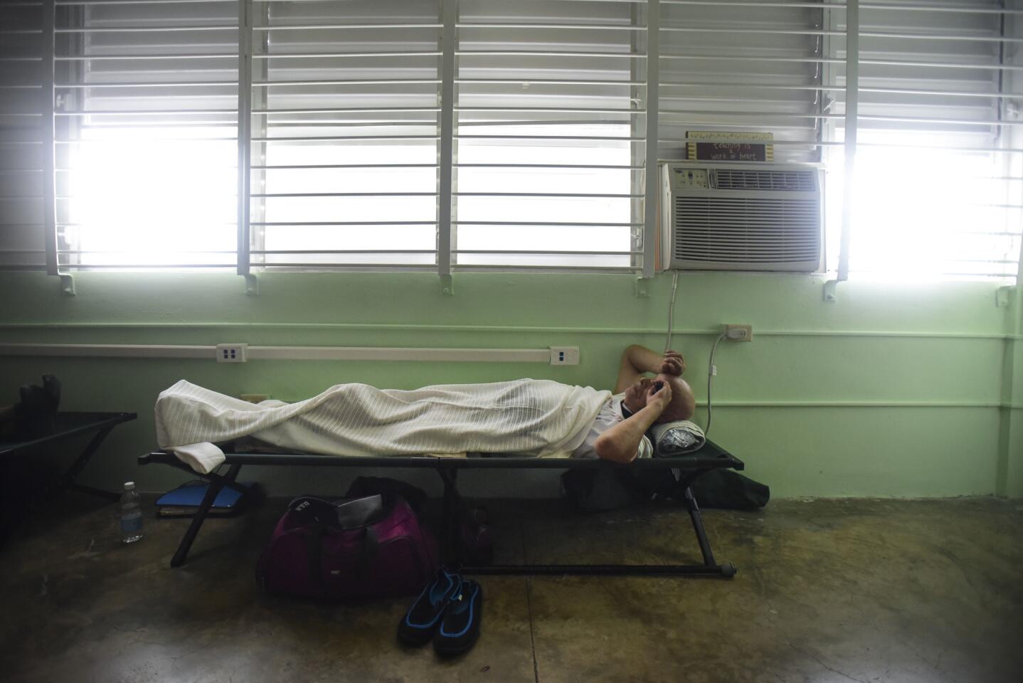 A man rests on a cot inside a shelter set up at the Berta Zalduondo elementary school during the passage of Hurricane Irma in Fajardo, northeast Puerto Rico, Sept. 6, 2017. Heavy rain and high winds lashed Puerto Rico's northeast coast Wednesday as Hurricane Irma roared through Caribbean islands.