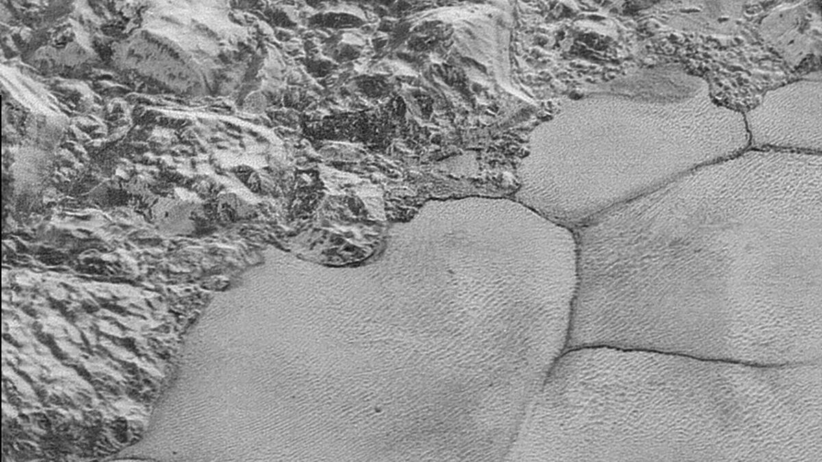 A mountain range on Pluto ends abruptly at the shoreline of the informally named "Sputnik Planum" on Pluto.