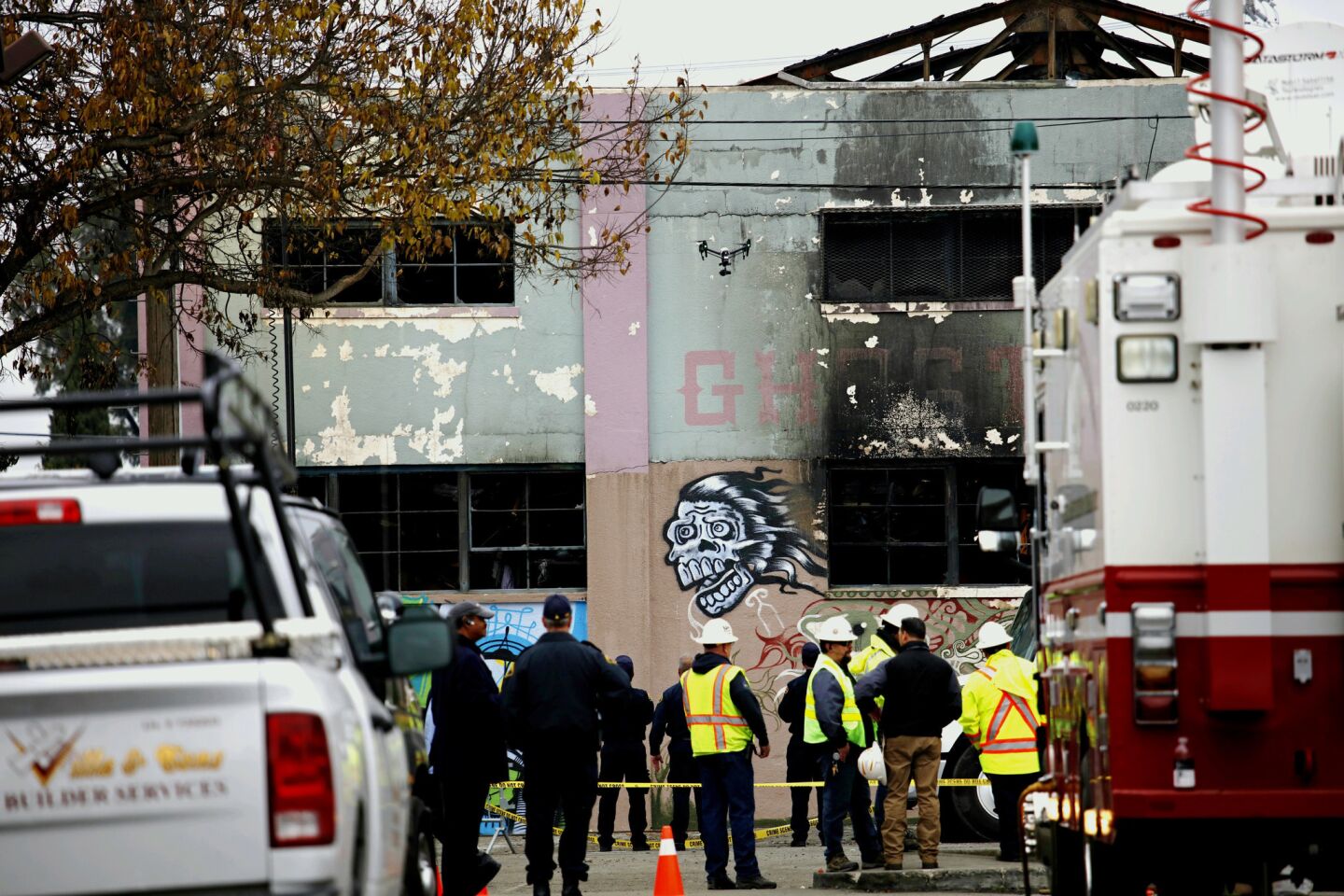 A drone flies over investigators outside Oakland's Ghost Ship warehouse, where 36 people died this month in one of the worst fires in modern California history.