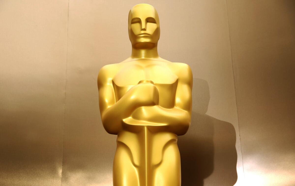 An Oscar statue stands on the red carpet as preparations are made for the 86th Academy Awards in Los Angeles.