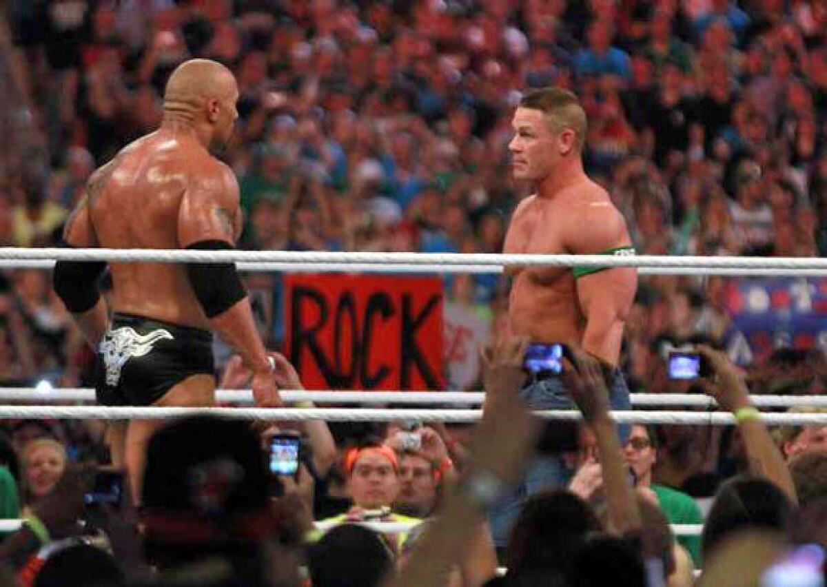 The Rock, left, takes on John Cena at WrestleMania.