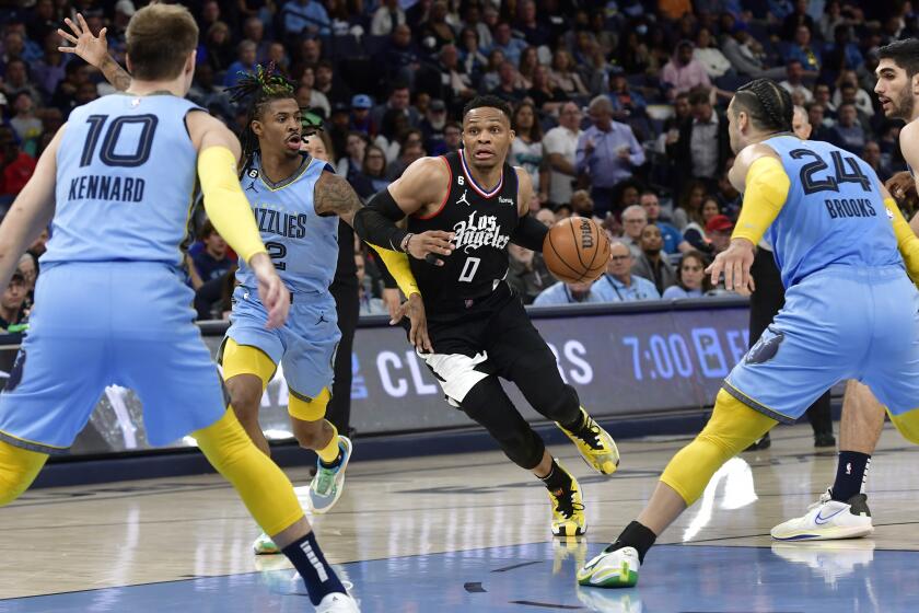 Los Angeles Clippers guard Russell Westbrook (0) drives against Memphis Grizzlies guard Ja Morant in the second half of an NBA basketball game, Wednesday, March 29, 2023, in Memphis, Tenn. (AP Photo/Brandon Dill)