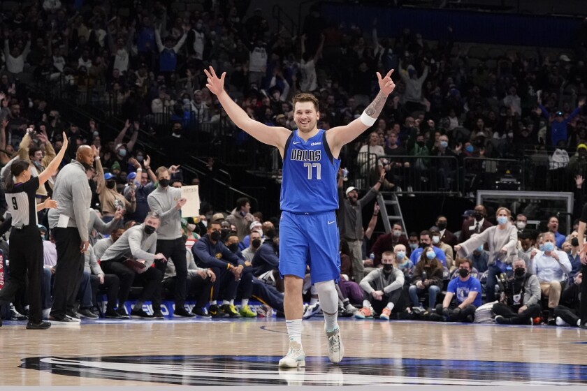 Dallas Mavericks guard Luka Doncic (77) reacts to a three-point basket during the second half of an NBA basketball game against the Dallas Mavericks in Dallas, Monday, Jan. 3, 2022. (AP Photo/LM Otero)