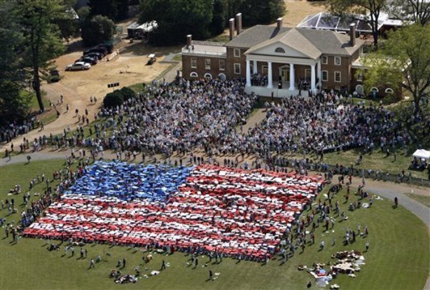 People gathered on the lawn of James Madison's home in Montpelier, Virginia, to display the U.S. flag in a card display, 2011. AP photo? 