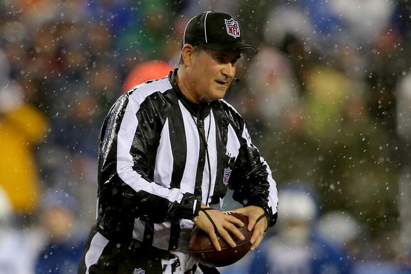 Official Carl Paganelli holds a ball during the AFC Championship game between the New England Patriots and Indianapolis Colts on Jan. 18.