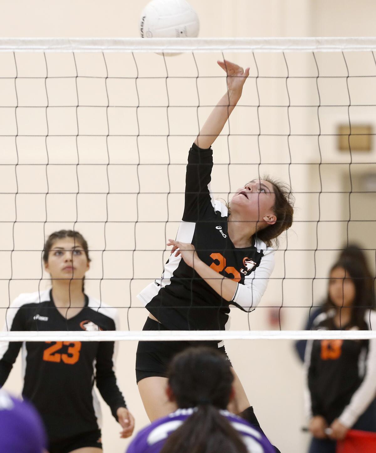 Los Amigos' Jasmine Torres hits against Santiago during the second set of a Garden Grove League match at home Tuesday.