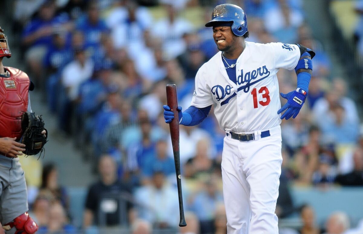Dodgers shortstop Hanley Ramirez, playing with a broken rib, grimaces in pain after swinging at a pitch in the first inning of the Dodgers' 4-2 loss to the St. Louis Cardinals in Game 4 of the NLCS.