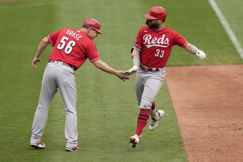 Cincinnati Reds' Jesse Winker (33) is congratulated by third base coach J.R. House after hitting a solo home run during the ninth inning of a baseball game against the St. Louis Cardinals Sunday, June 6, 2021, in St. Louis. (AP Photo/Jeff Roberson)