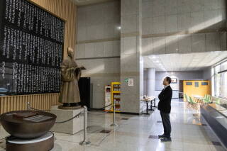 A man looks at a statue of King Sejong, who invented Hangeul, the Korean alphabet, in 1443