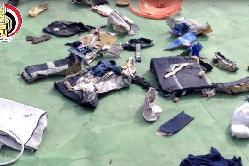 Egyptian officials display personal belongings and other wreckage from EgyptAir Flight 804.