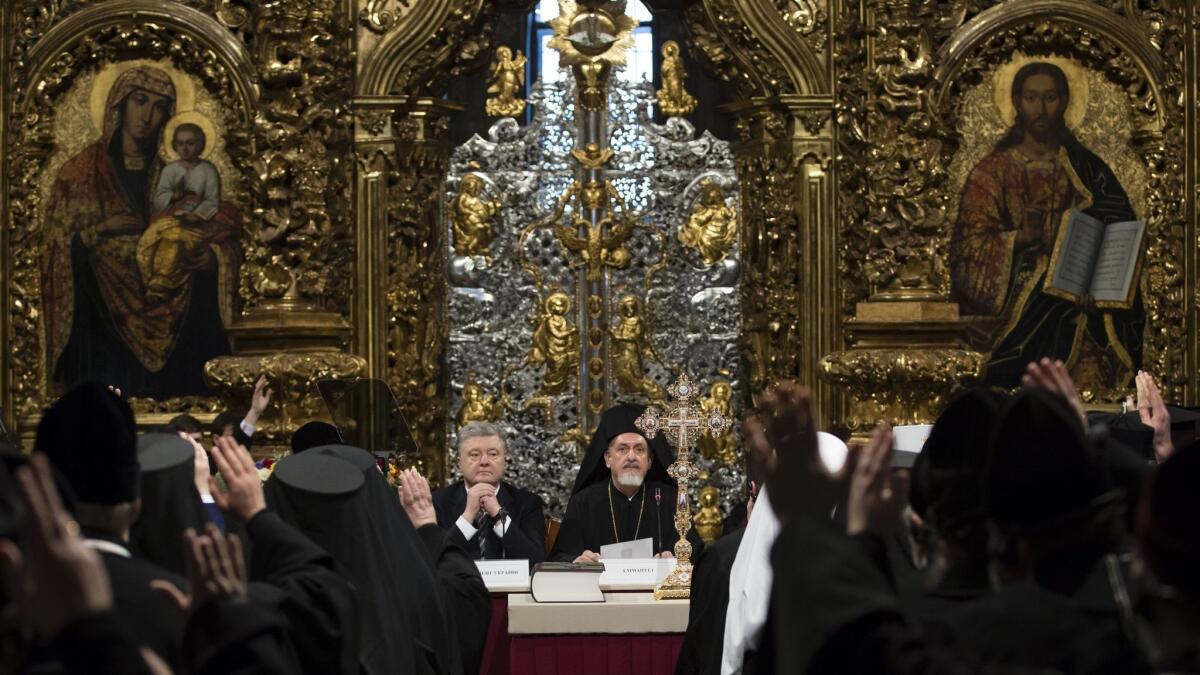 Ukrainian President Petro Poroshenko, center left, attends a closed-door synod of three Ukrainian Orthodox churches to approve the charter for a unified church and to elect leadership in the St. Sophia Cathedral in Kiev on Saturday.