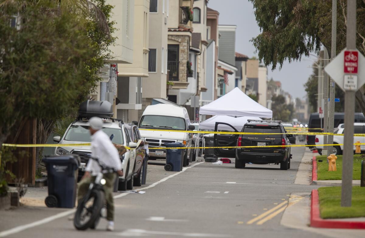 Huntington Beach police personnel investigate the site of an officer involved shooting in Sunset Beach on Monday.