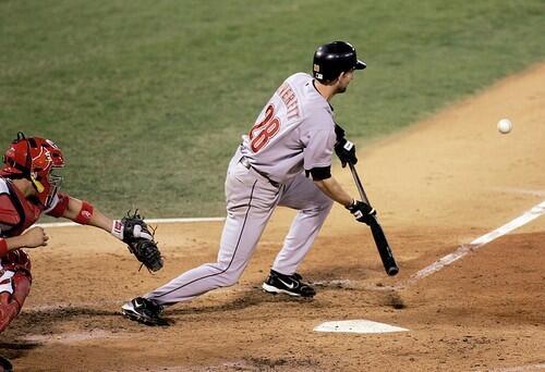 The Astros' Adam Everett bunts to drive in teammate Chris Burke off of Cardinal pitcher Jason Marquis