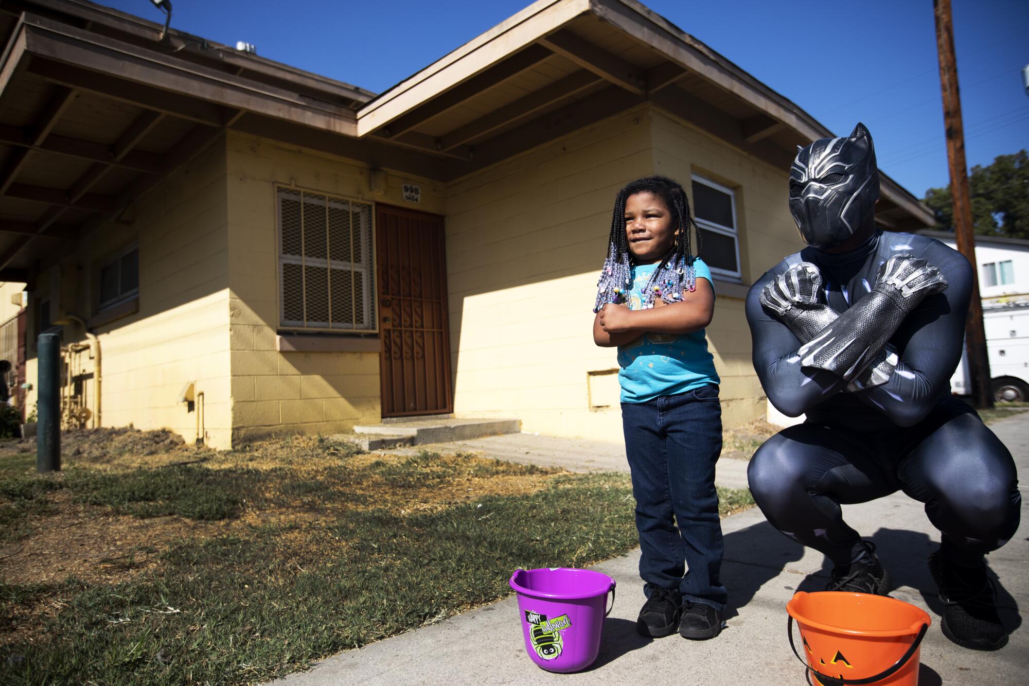 Rakeem Addison, right, strikes a pose with Aadori Jackson, 4, at Nickerson Gardens in the Watts neighborhood of Los Angeles.