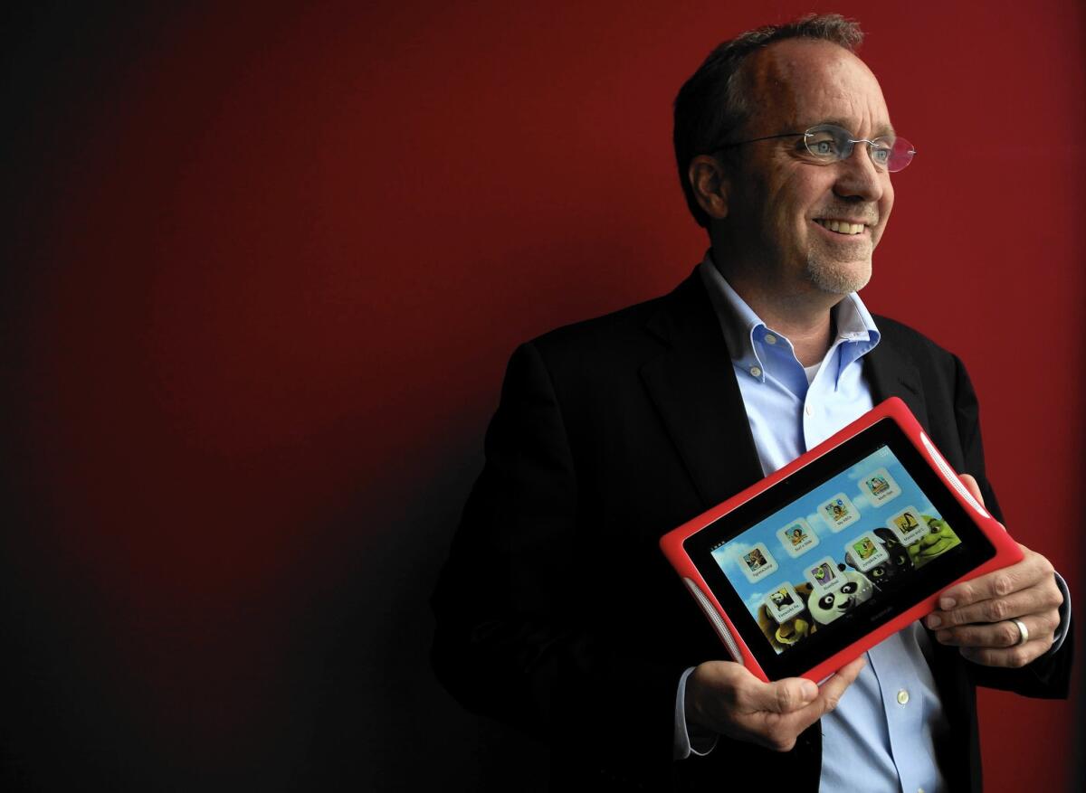 Fuhu CEO Jim Mitchell holds one of the El Segundo children's tablet maker's products in March 2014. He said Fuhu expects “to be able to satisfy ongoing obligations” with its proposed sale to Mattel.