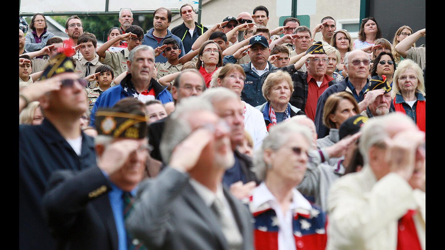 Veterans and Boy Scouts salute as the National Anthem is sung at the Memorial Day ceremony at Two Strike War Memorial in La Crescenta on Monday, May 30, 2016.