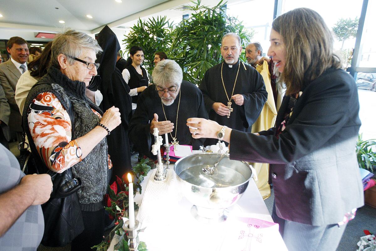 Blessed water is given to hospital staff for personal use, or to take to patients, after the celebration of the New Year and Armenian Christmas with the "Blessing of the Water" ceremony conducted at the entrance of Glendale Memorial Hospital by His Eminence Archbishop Moushegh Mardirosian, Prelate of the Western United States of America on Friday, January 3, 2014.