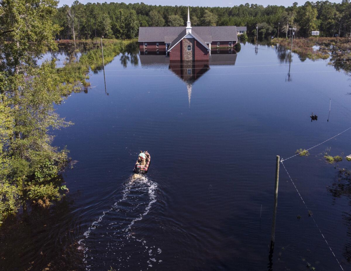 Avery Singleton takes a boat to Pine Grove Baptist Church in Brittons Neck, S.C.