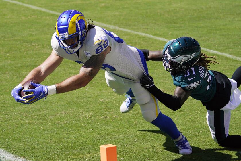 Los Angeles Rams' Tyler Higbee, left, reaches for a touchdown against Philadelphia Eagles' Nickell Robey-Coleman.