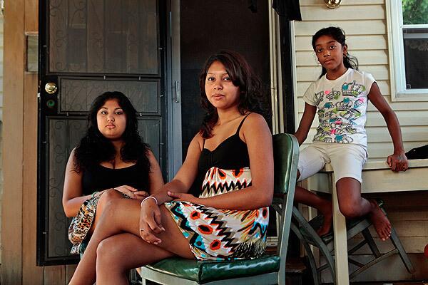 From left, Ashley Ramsaroop, 15, and sisters Tiffany, 18, and Kimberly, 10, whose father, a maintenance worker at the World Trade Center, died in the Sept. 11 attacks.