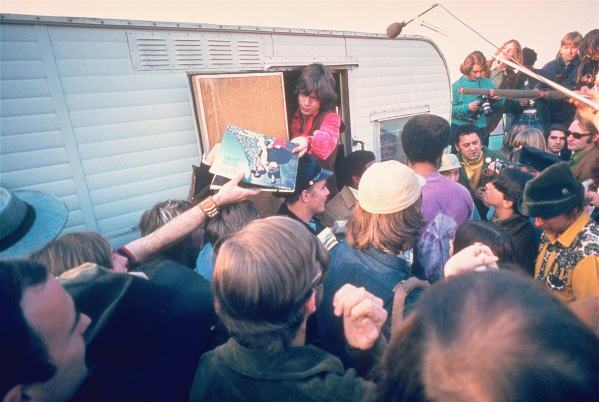 Mick Jagger signs autographs for fans at the Altamont Race Track on Dec. 8, 1969. 