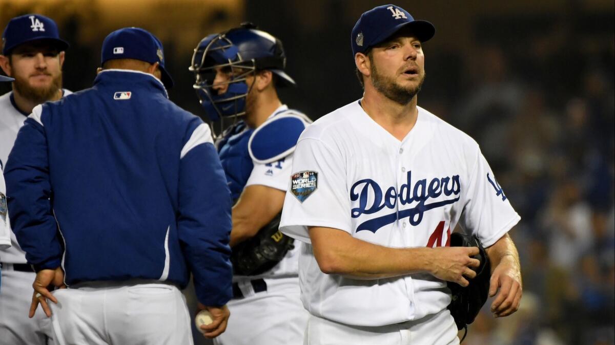 Rich Hill walks to the dugout after being relieved during the seventh inning of Game 4 against the Boston Red Sox.
