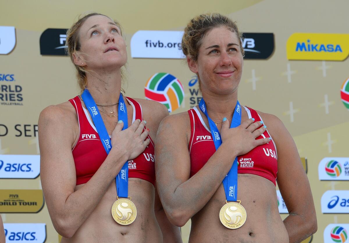 Kerry Walsh Jennings and April Ross stand on the podium after winning the gold medal at the FIVB Long Beach Grand Slam on July 27.