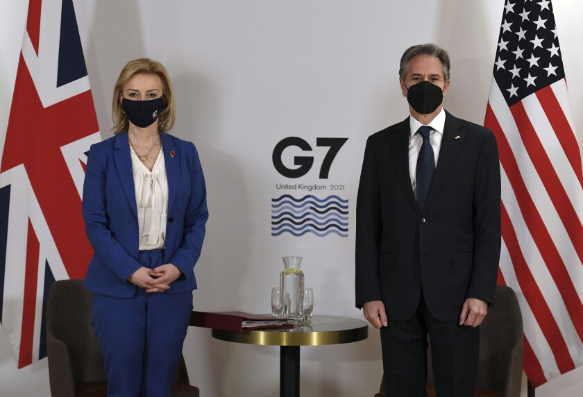 Britain's Foreign Secretary Liz Truss, left, and US Secretary of State Antony Blinken, wearing face coverings to combat the spread of the coronavirus, pose for a photograph before a bilateral meeting ahead of the G7 foreign ministers summit in Liverpool, England, Friday, Dec. 10, 2021. - Blinken arrived in Britain for a G7 ministers' meeting before visiting Indonesia, Malaysia and Thailand. (Olivier Douliery/Pool Photo via AP)