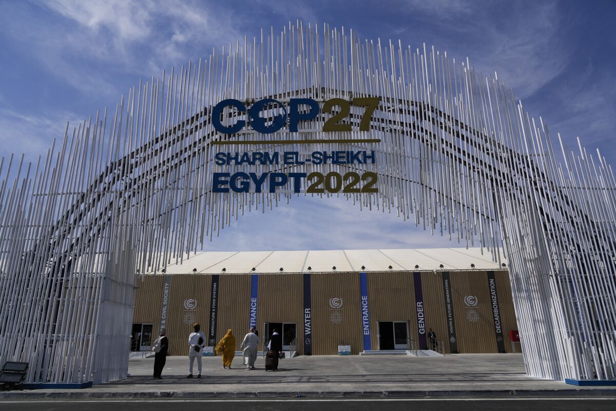 An elaborate arched sign reads "COP27 Sharm El-Sheikh Egypt 2022"