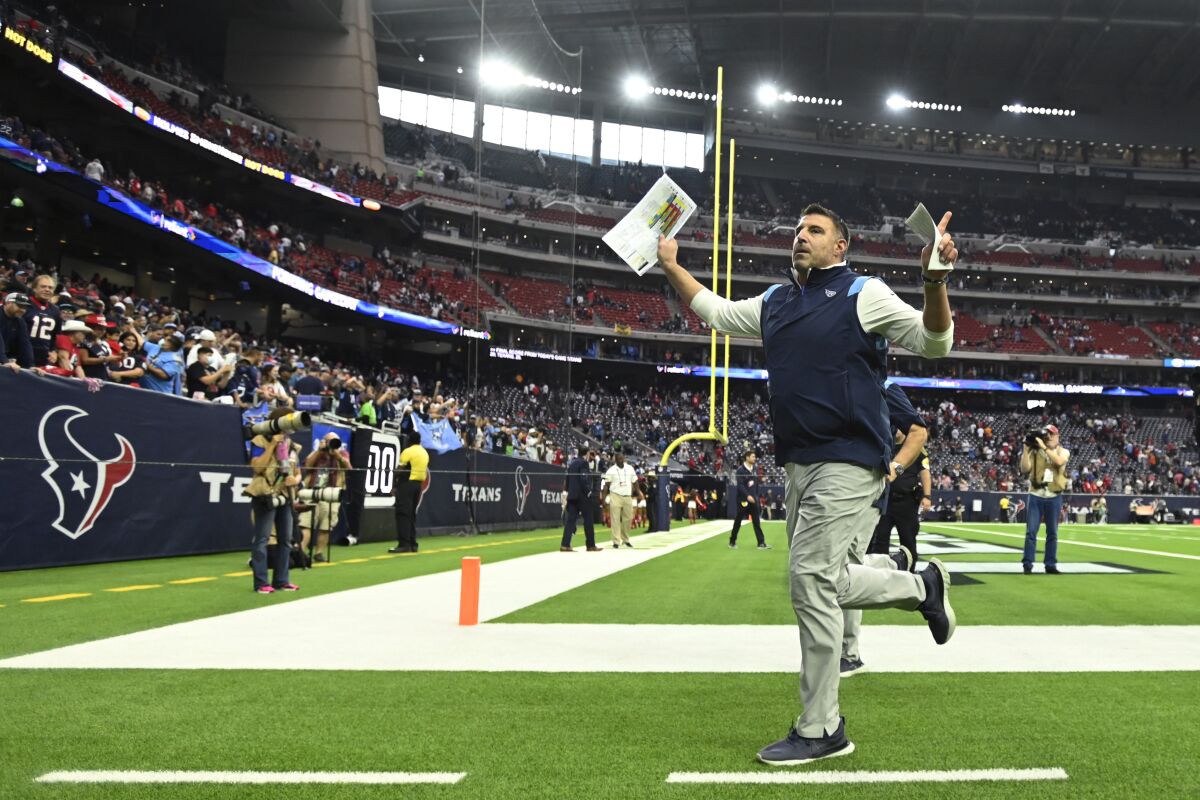 Tennessee Titans head coach Mike Vrabel celebrates with fans as he runs off the field after their win over the Houston Texans in an NFL football game, Sunday, Jan. 9, 2022, in Houston. (AP Photo/Justin Rex )