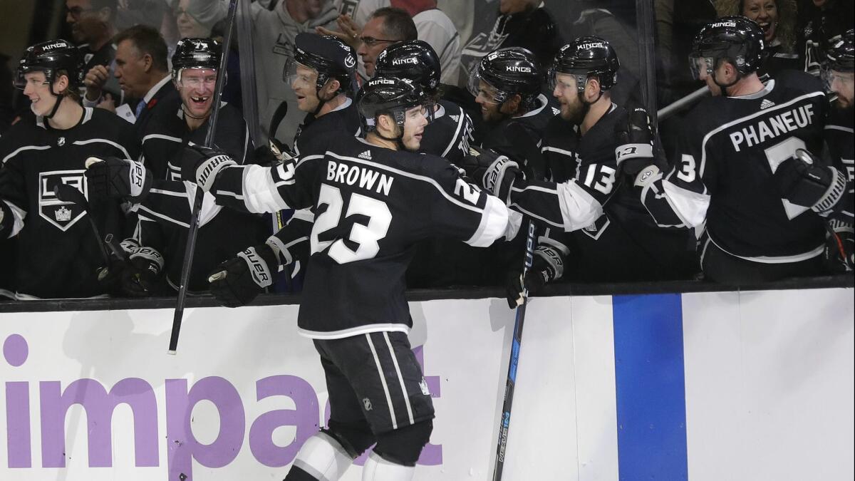 The Kings' Dustin Brown (23) is congratulated by teammates after scoring against the Columbus Blue Jackets during the third period on Saturday.