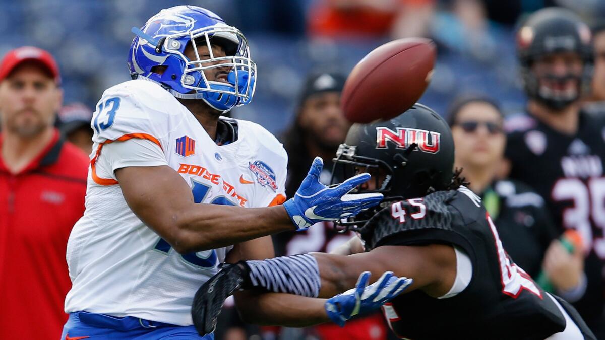 Boise State running back Jeremy McNichols makes a catch despite tight coverage by Northern Illinois linebacker Boomer Mays on Wednesday.