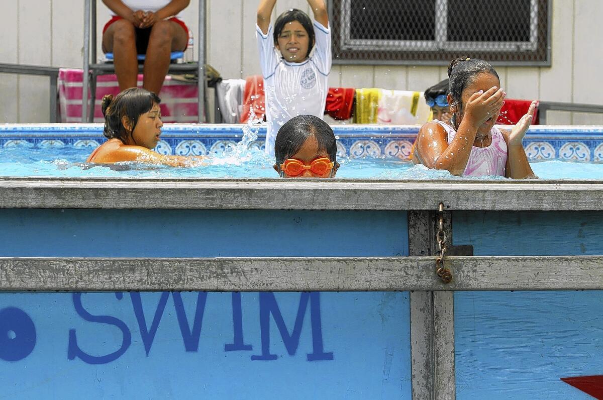 Angelica Rodriguez, 9, center, and other children learn to swim at Park Avenue Elementary School in Cudahy on Monday.