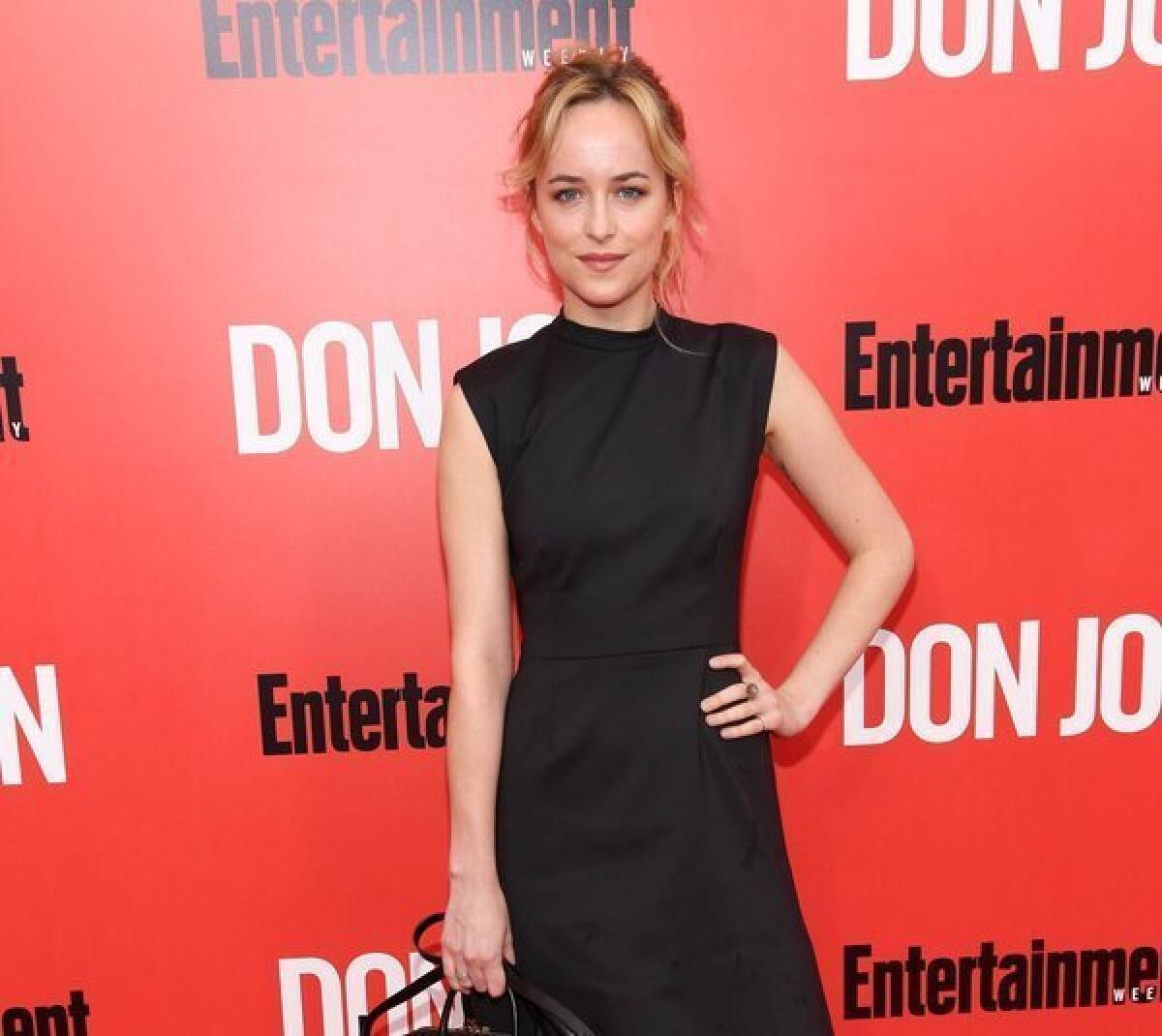 Actress Dakota Johnson, said to be sticking with the "Fifty Shades of Grey" adaptation, is seen at the New York premiere of "Don Jon."