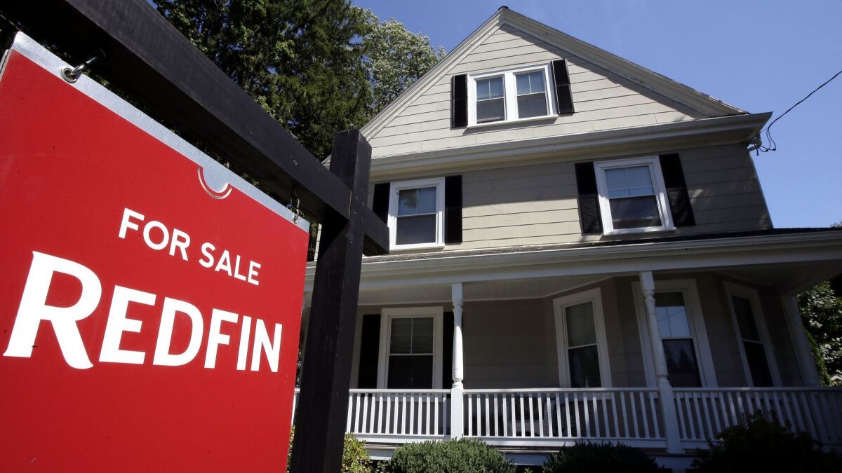 Redfin sale sign in front of home