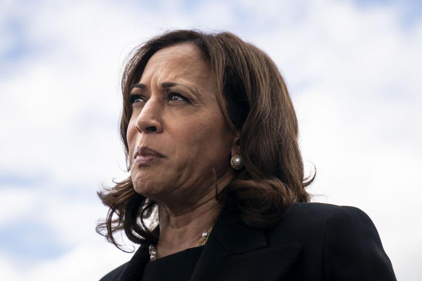 BUFFALO, NY - MAY 28: Vice President Kamala Harris speaks to the traveling press pool as Second Gentleman Doug Emhoff looks on, under the wing of Air Force 2 atBuffalo-Niagra International Airport on Saturday, May 28, 2022 in Buffalo, NY. Ruth Whitfield, whose funeral the Vice President and Second Gentleman attended earlier in the day, was one of ten people killed two weeks ago in what federal officials are calling an act of "racially motivated violent extremism," by a white man, in the shooting of a supermarket in a historically black neighborhood of Buffalo, NY. (Kent Nishimura / Los Angeles Times)