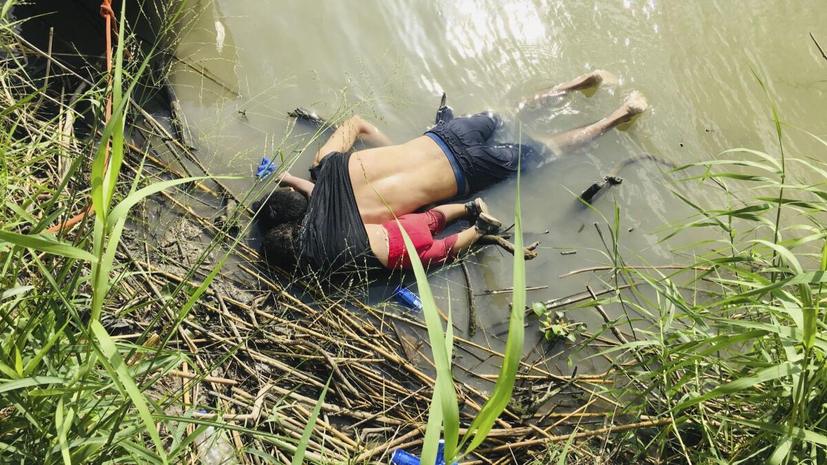 The bodies of Salvadoran migrant Oscar Alberto Martinez Ramirez and his nearly 2-year-old daughter, Valeria, lie on the bank of the Rio Grande in Matamoros, Mexico, after they drowned trying to cross the river to Brownsville, Texas, on June 24.
