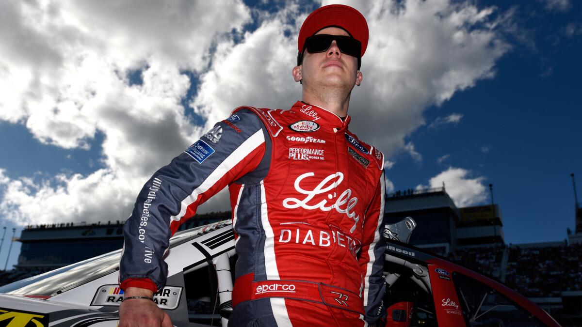 NASCAR driver Ryan Reed stands on the grid before the start of the Xfinity Series race at Daytona International Raceway on Saturday.