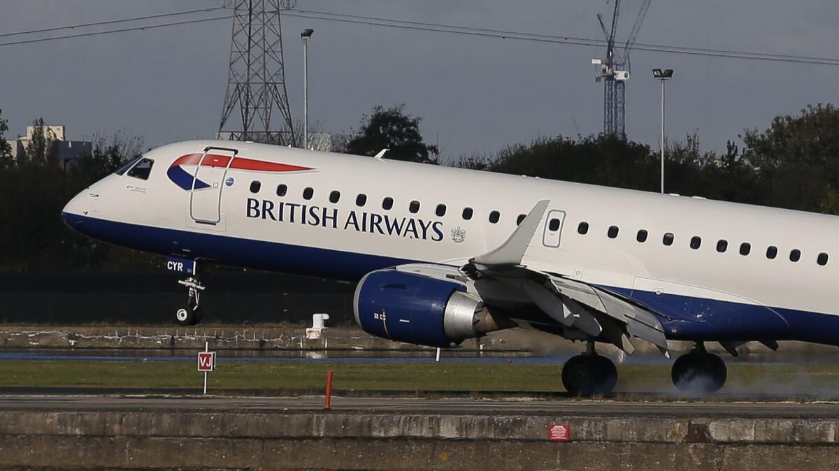 A British Airways E190 Embraer airplane lands at London City Airport.