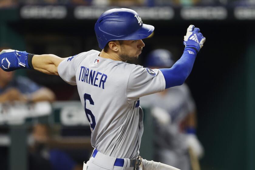 Los Angeles Dodgers batter Trea Turner follows through.