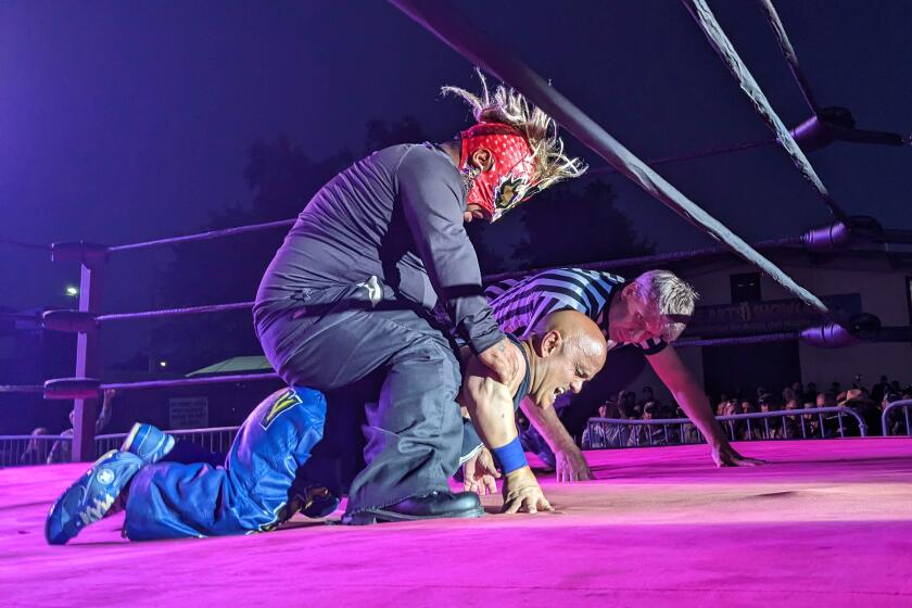 Midget Wrestling Warriors' promoter and star Short-Sleeve Sampson, aka Daniel DiLucchio, fights Jessie "the Rock" Salazar, a fellow dwarf performer, at a sold out show at the Sonoma County Fair on Aug. 3, 2023, while the referee looks on. The event drew strong condemnation from the Bay Area's large dwarf community and other disabled activists, who say "midget" is a slur and argue the sport stokes bigotry and public harassment.