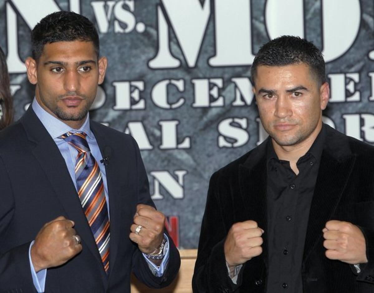 Amir Khan, left, will face Carlos Molina on Saturday at the Sports Arena.