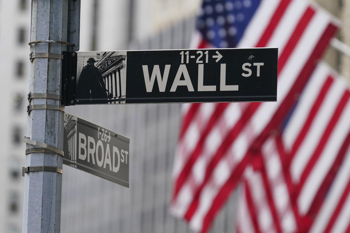 A Wall Street sign is seen in front of the New York Stock Exchange