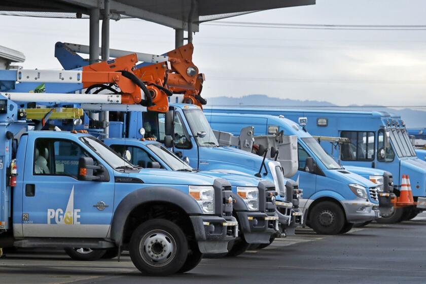 FILE - This Jan. 14, 2019 file photo shows Pacific Gas & Electric vehicles parked at the PG&E Oakland Service Center in Oakland, Calif. PG&E is expected to file for bankruptcy protection Tuesday, Jan. 29, 2019. (AP Photo/Ben Margot, File)