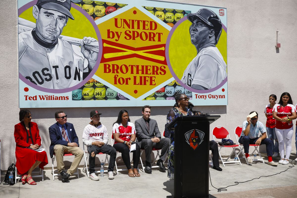 Alicia Gwynn speaks at Hoover High on Tuesday during unveiling of mural depicting Ted Williams and Tony Gwynn.